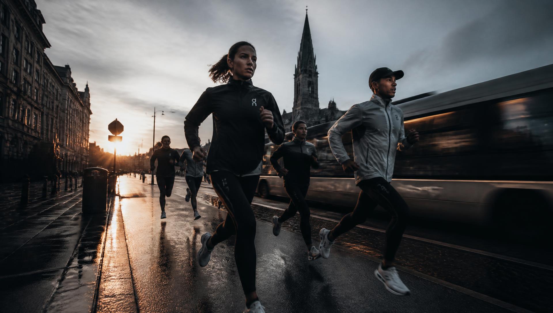 Runners at dawn on a wet city street